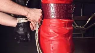 Good Busty Doll In Red Latex Outfit Is Being Created For Domination