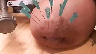 Sweet Hottie Penetrates Her Own Big Tits With Needles